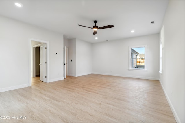 empty room with light hardwood / wood-style flooring and ceiling fan