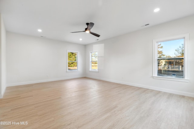 empty room featuring ceiling fan and light wood-type flooring