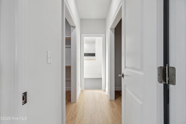 corridor with light hardwood / wood-style flooring