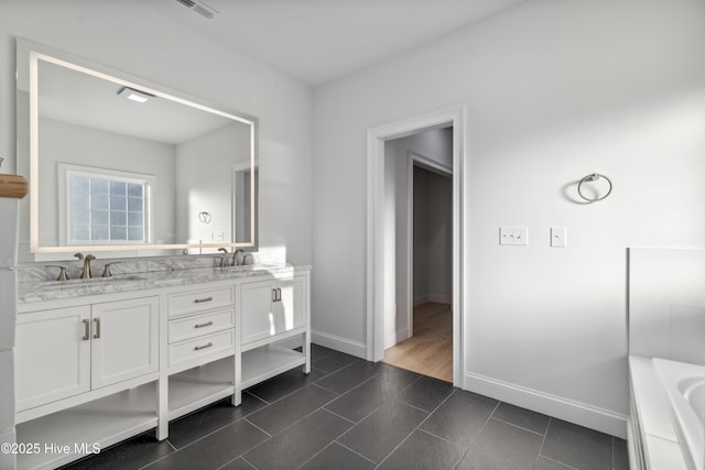 bathroom with vanity, tile patterned floors, and a bathing tub