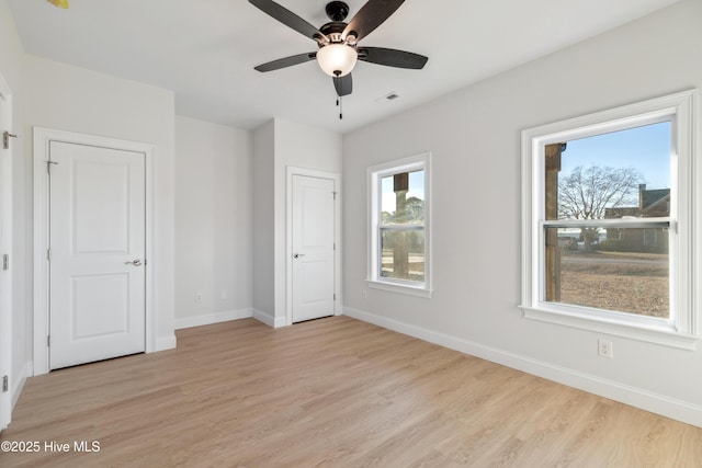 unfurnished bedroom featuring ceiling fan and light wood-type flooring