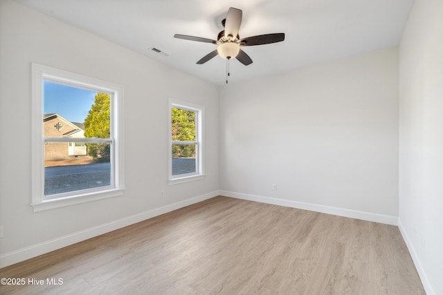 empty room featuring ceiling fan and light hardwood / wood-style flooring