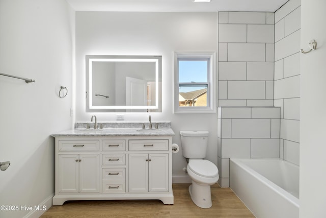 full bathroom with vanity, toilet, and tiled shower / bath combo