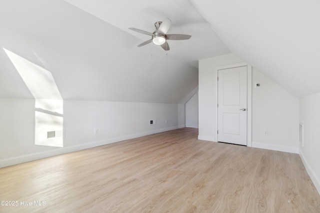 additional living space featuring vaulted ceiling, ceiling fan, and light hardwood / wood-style floors