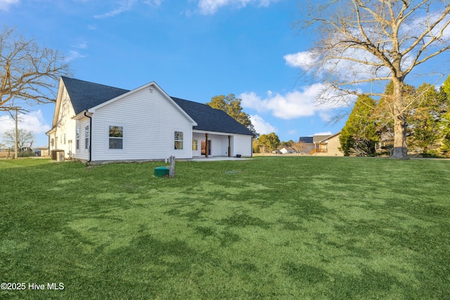 back of property featuring a patio and a lawn