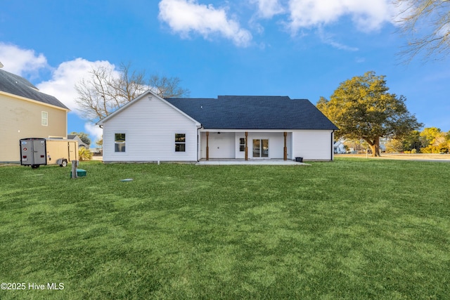 rear view of house with a patio and a lawn