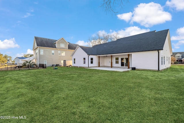 back of property with a patio and a yard