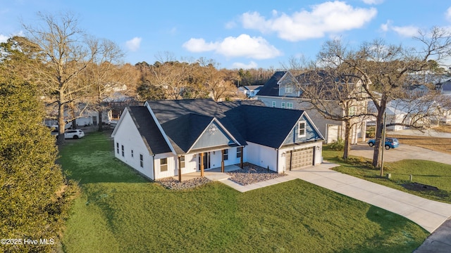 view of front of property with a garage and a front lawn