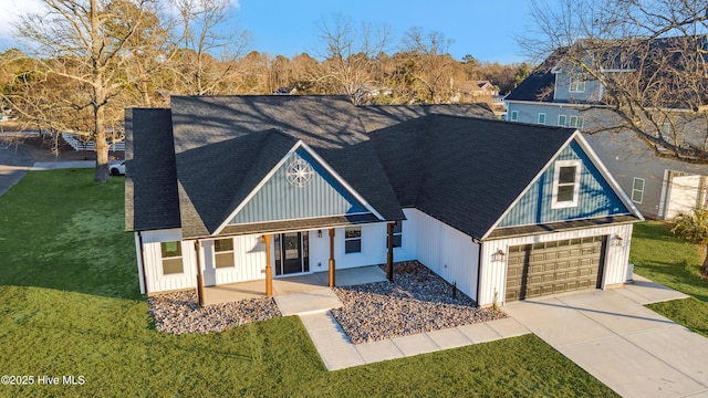 view of front of house featuring a garage, a patio, and a front yard