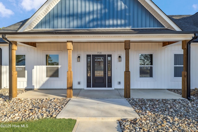 view of exterior entry featuring covered porch