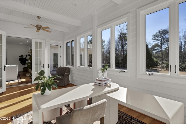 sunroom featuring beam ceiling, ceiling fan, and wood ceiling