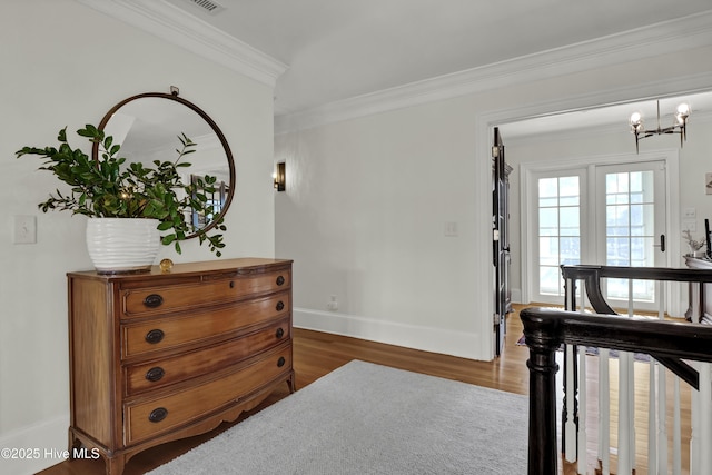 bedroom with crown molding, a chandelier, and dark hardwood / wood-style flooring