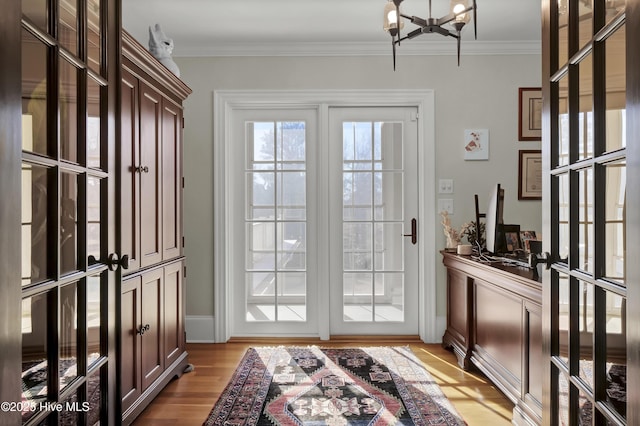 entryway featuring light hardwood / wood-style flooring, crown molding, and french doors