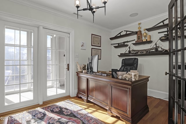 home office with a notable chandelier, crown molding, and hardwood / wood-style floors