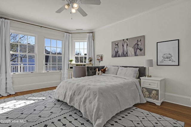 bedroom with ceiling fan, hardwood / wood-style flooring, and crown molding