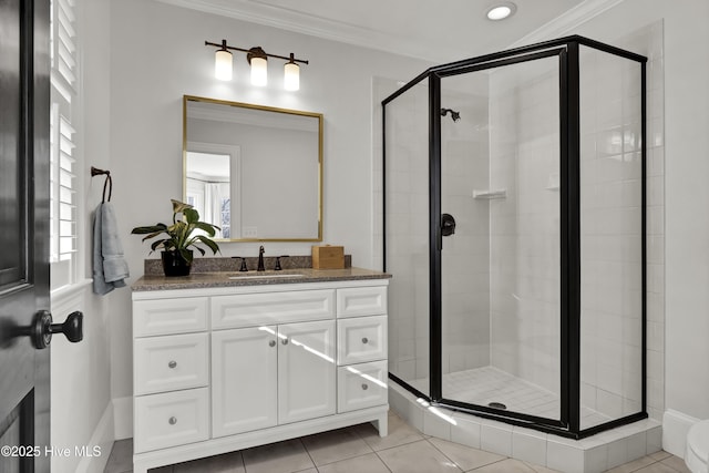 bathroom with tile patterned floors, ornamental molding, vanity, and a shower with shower door