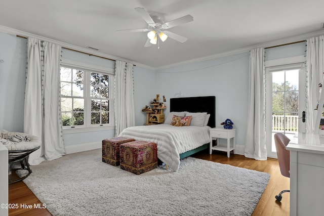 bedroom featuring access to exterior, hardwood / wood-style floors, crown molding, and ceiling fan