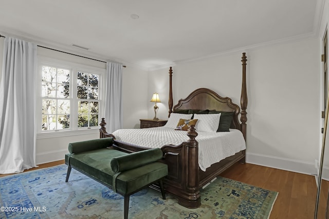 bedroom featuring hardwood / wood-style flooring and ornamental molding