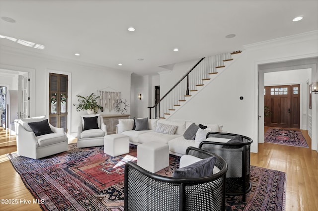 living room featuring hardwood / wood-style flooring and crown molding