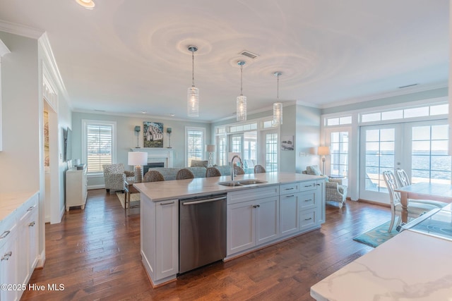 kitchen with white cabinetry, sink, stainless steel dishwasher, and decorative light fixtures