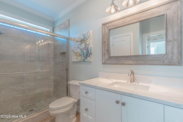 bathroom featuring a shower with door, vanity, a wealth of natural light, ornamental molding, and toilet