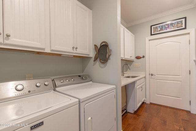 washroom with sink, dark hardwood / wood-style flooring, crown molding, cabinets, and washing machine and dryer