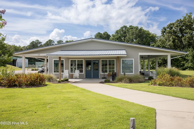 view of front of property featuring a carport, covered porch, and a front lawn