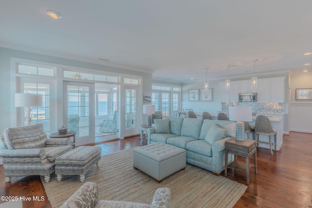 living room featuring ornamental molding and hardwood / wood-style floors