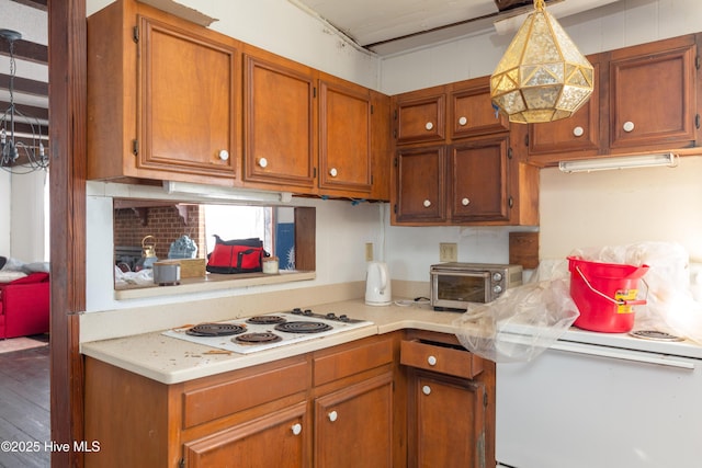 kitchen with pendant lighting and white cooktop