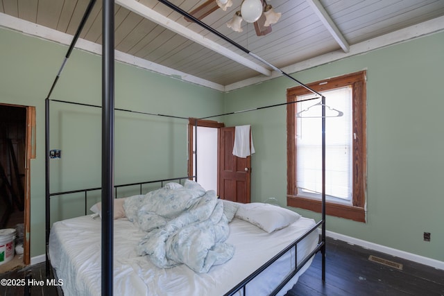 bedroom with dark wood-type flooring