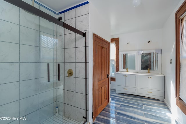 bathroom with an enclosed shower and vanity