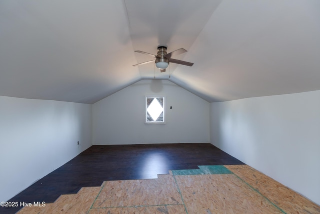 additional living space with dark hardwood / wood-style flooring, ceiling fan, and vaulted ceiling