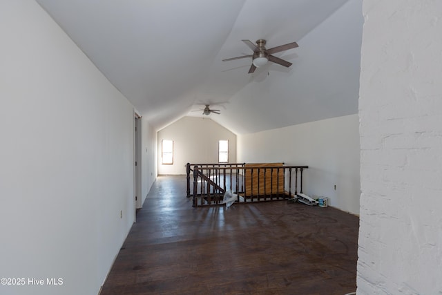 additional living space with ceiling fan, dark hardwood / wood-style flooring, and lofted ceiling