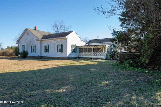 back of house with a lawn