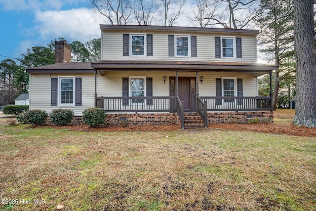 view of front facade with covered porch and a front lawn