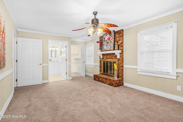 unfurnished living room with a brick fireplace, ceiling fan, crown molding, and light carpet