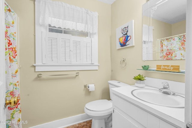 bathroom with toilet, vanity, and tile patterned floors