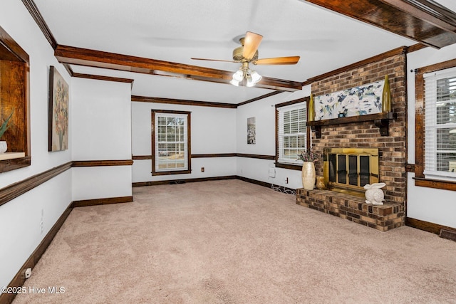 unfurnished living room with a brick fireplace, light carpet, ornamental molding, and ceiling fan