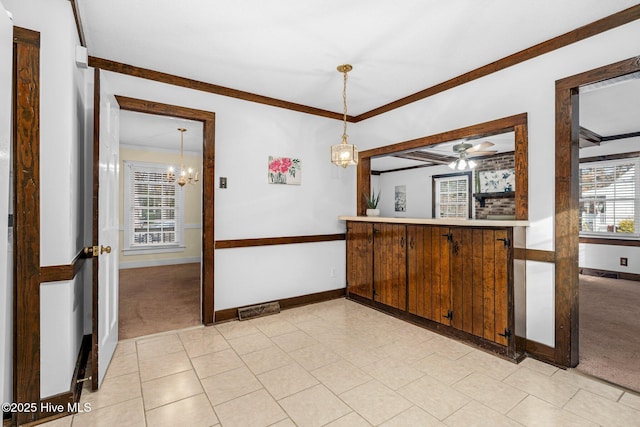 kitchen featuring ceiling fan with notable chandelier, light colored carpet, and crown molding