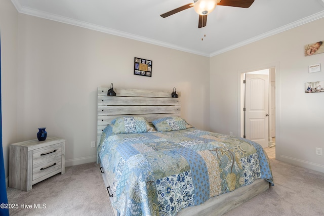 carpeted bedroom with ornamental molding and ceiling fan