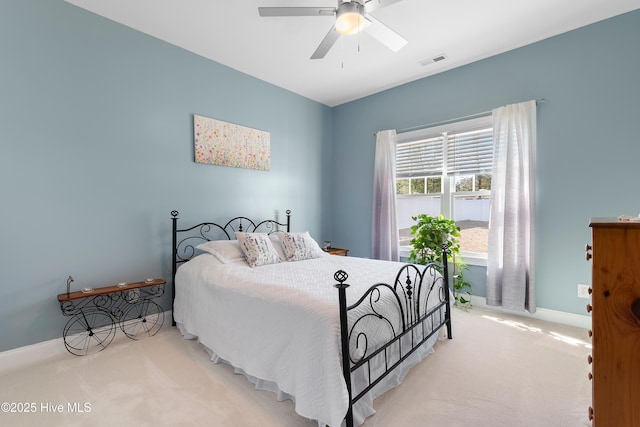 bedroom with ceiling fan and light carpet