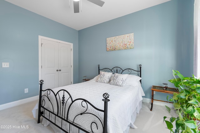 bedroom with light carpet, a closet, and ceiling fan