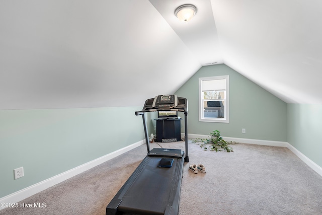 workout area featuring carpet floors and vaulted ceiling