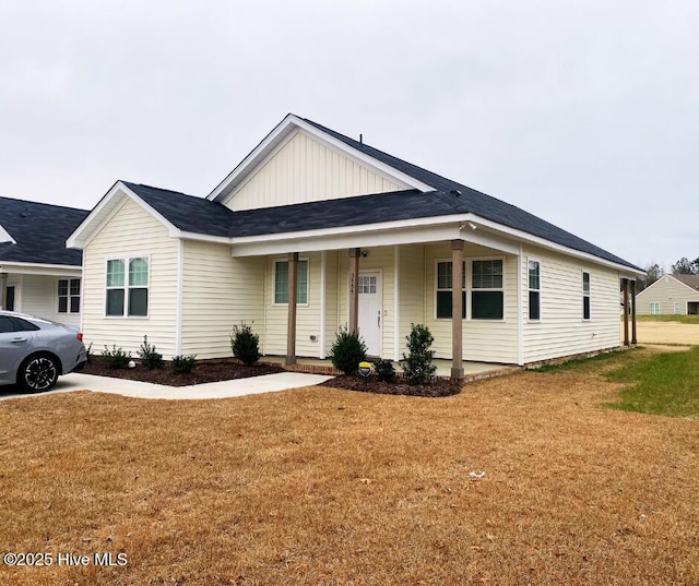 view of front of home featuring covered porch and a front yard