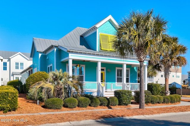 view of front facade featuring metal roof and a porch