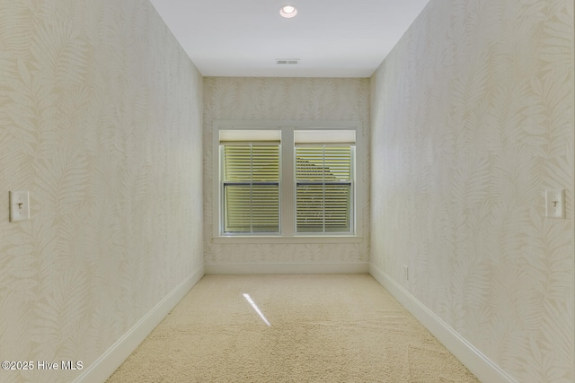 carpeted empty room with wallpapered walls, baseboards, and recessed lighting