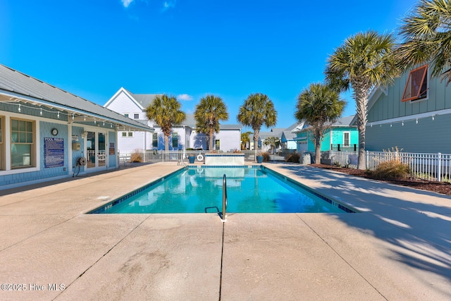 community pool featuring a patio and fence