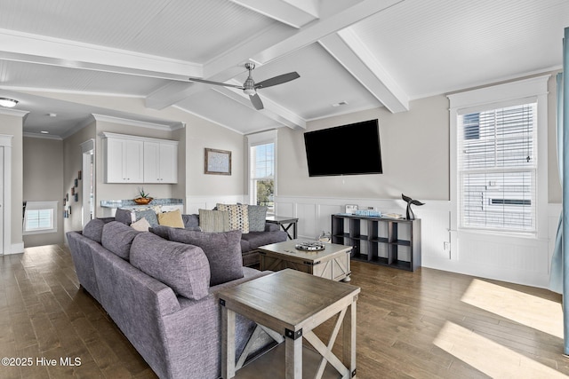 living room with ceiling fan, lofted ceiling with beams, dark hardwood / wood-style flooring, and crown molding