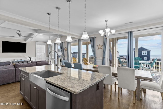 kitchen with light stone counters, sink, pendant lighting, and dishwasher