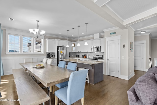 dining room featuring beam ceiling, dark hardwood / wood-style flooring, ornamental molding, and a notable chandelier